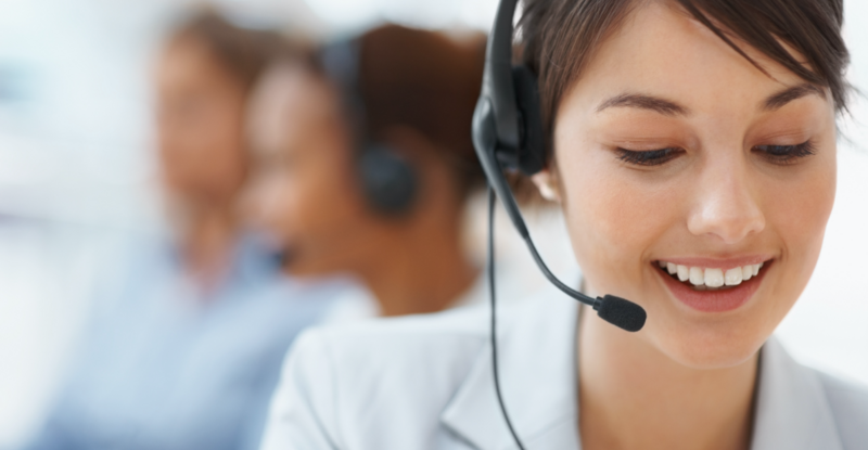 A friendly woman with a headset takes a call